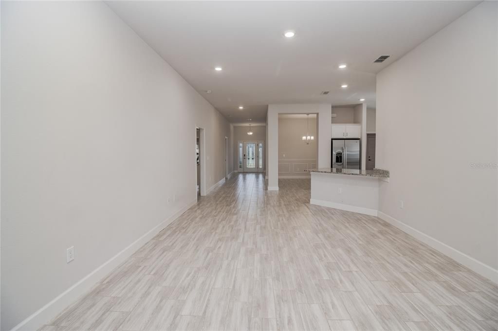 Empty room, Interior, Kitchen, Recessed Lighting, Stainless Steel Appliances, Wood Texture Flooring