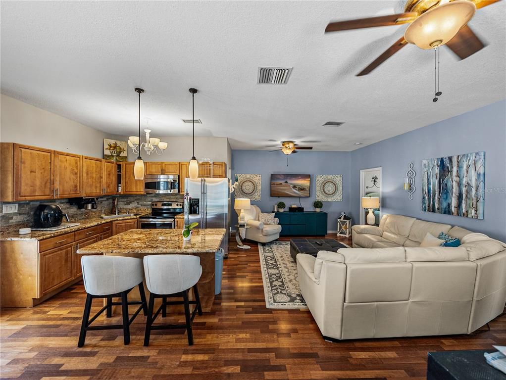 Chandelier, Dining room, Interior, Kitchen, Living room, Pendant Lights, Stainless Steel Appliances, Wood Texture Flooring