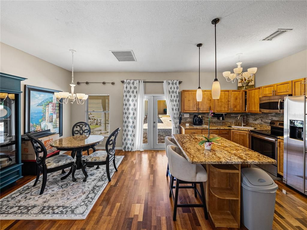 Chandelier, Dining room, Interior, Kitchen, Pendant Lights, Stainless Steel Appliances, Wood Texture Flooring