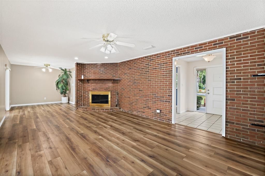 Empty room, Fireplace, Interior, Recessed Lighting, Stone Walls, Wood Texture Flooring