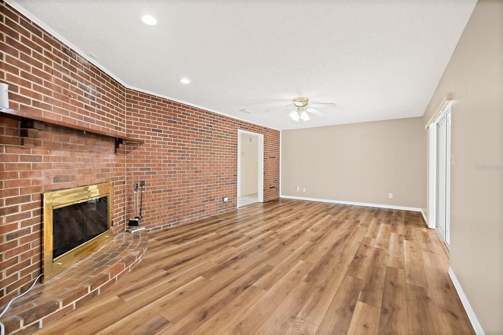 Empty room, Fireplace, Interior, Recessed Lighting, Stone Walls, Wood Texture Flooring
