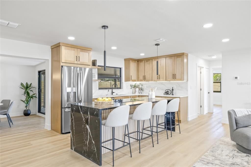 Interior, Kitchen, Marble Walls, Pendant Lights, Recessed Lighting, Stainless Steel Appliances, Wood Texture Flooring