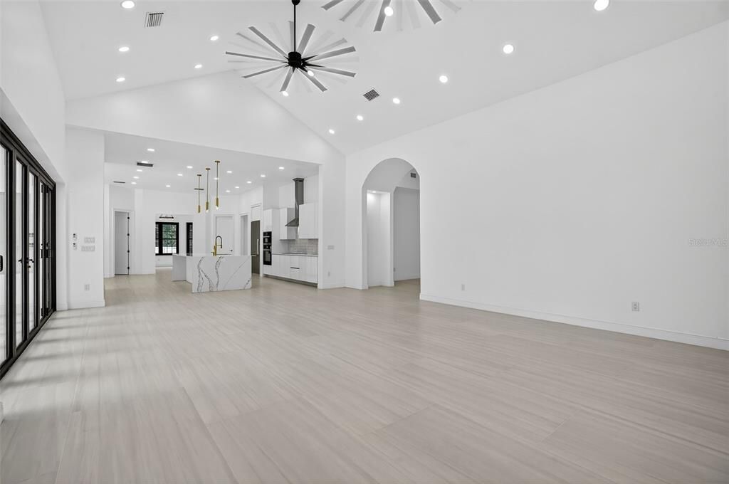 Empty room, Interior, Kitchen, Pendant Lights, Recessed Lighting, Stainless Steel Appliances, Wood Texture Flooring
