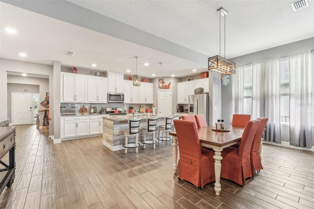 Dining room, Interior, Kitchen, Pendant Lights, Recessed Lighting, Stainless Steel Appliances, Wood Texture Flooring