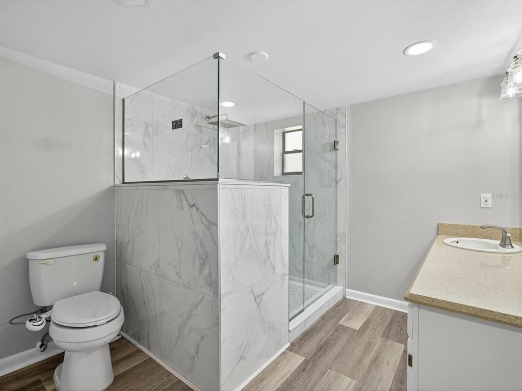 Bathroom, Glass Shower, Interior, Marble Walls, Recessed Lighting, Wood Texture Flooring