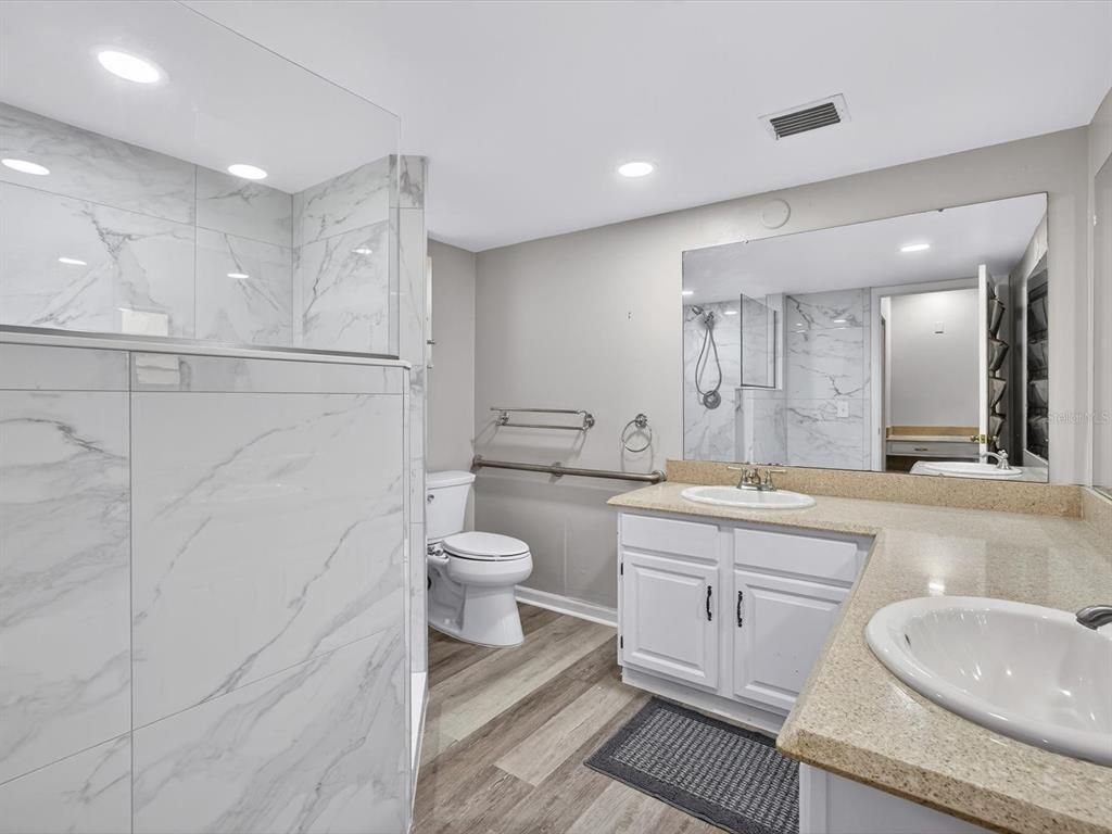Bathroom, Dual Sink Vanities, Interior, Marble Walls, Recessed Lighting, Wood Texture Flooring