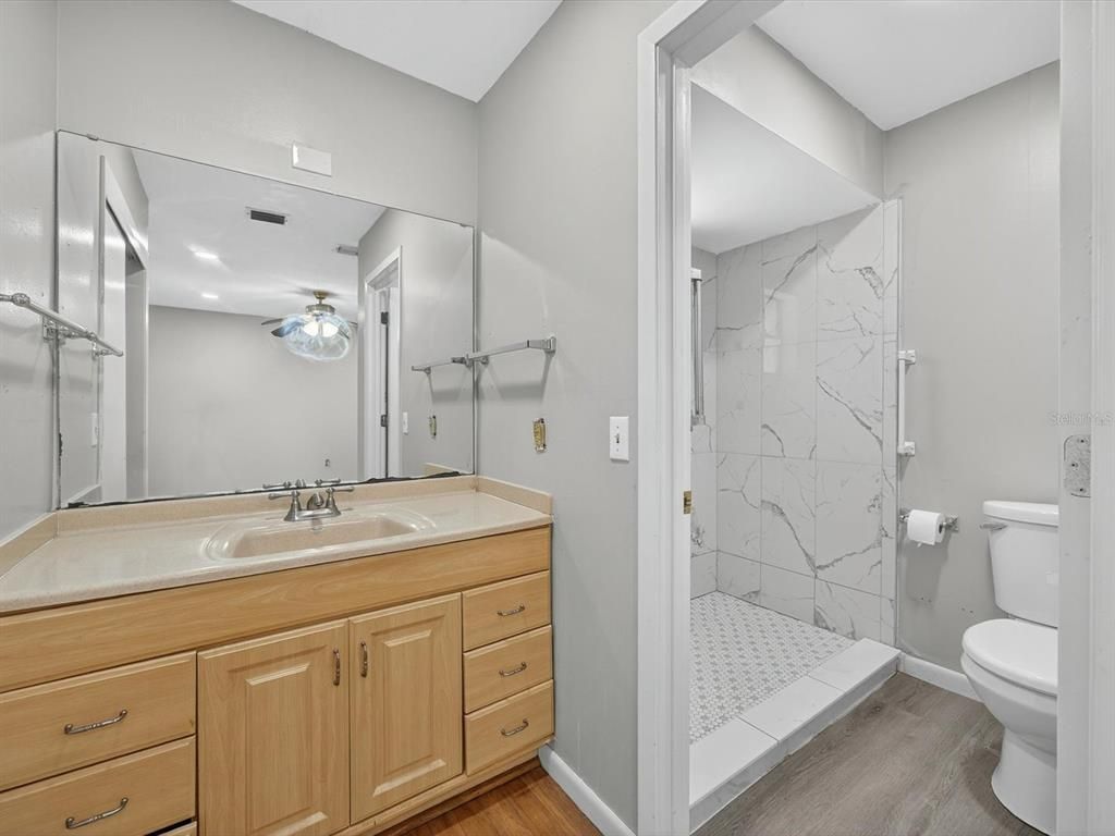 Bathroom, Glass Shower, Interior, Marble Walls, Recessed Lighting, Wood Texture Flooring