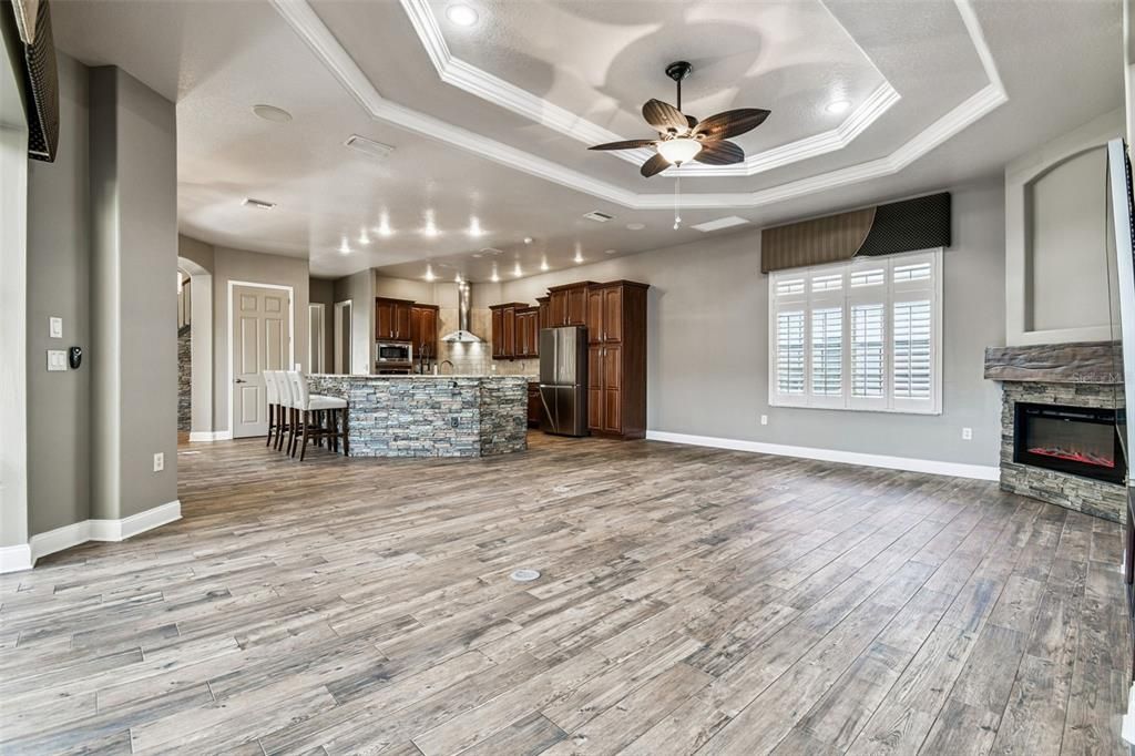 Dining room, Fireplace, Interior, Kitchen, Recessed Lighting, Stainless Steel Appliances, Wood Texture Flooring
