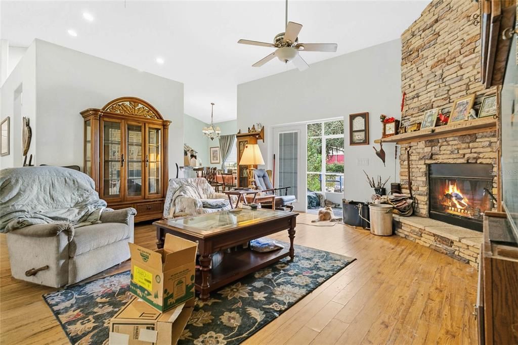 Chandelier, Fireplace, Interior, Living room, Recessed Lighting, Stone Walls, Wood Texture Flooring