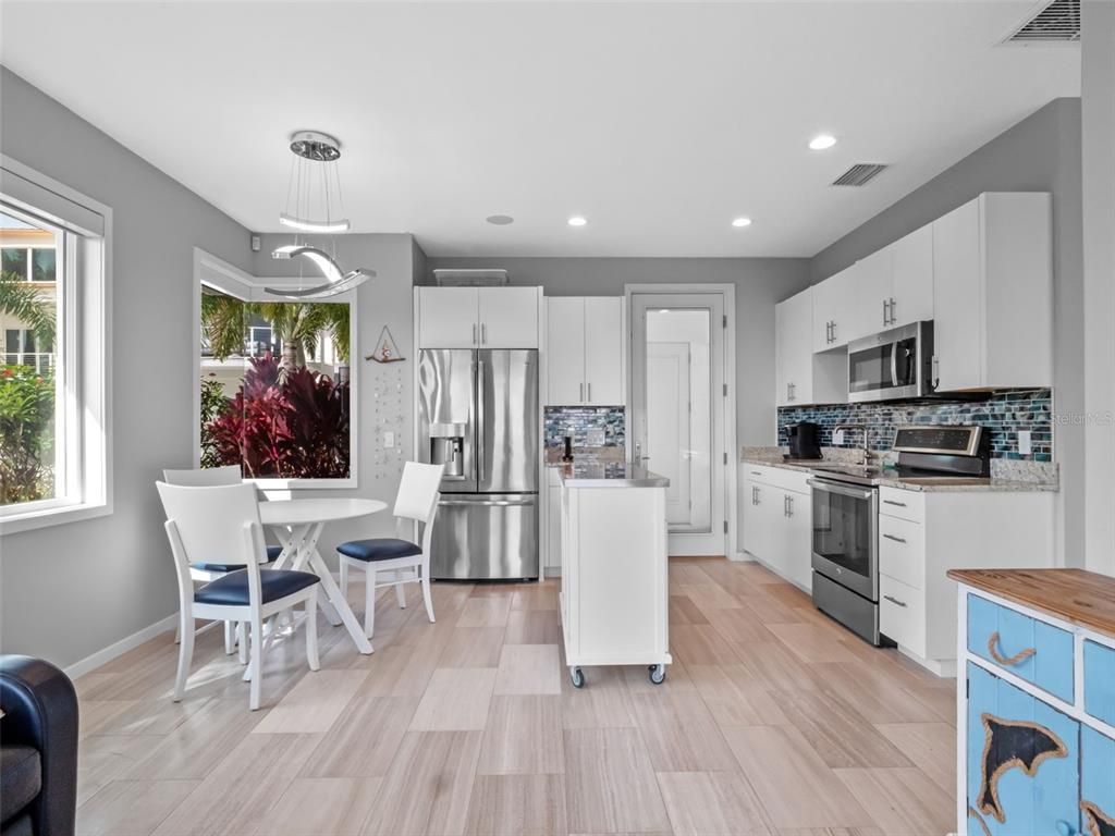 Dining room, Interior, Kitchen, Pendant Lights, Recessed Lighting, Stainless Steel Appliances, Wood Texture Flooring