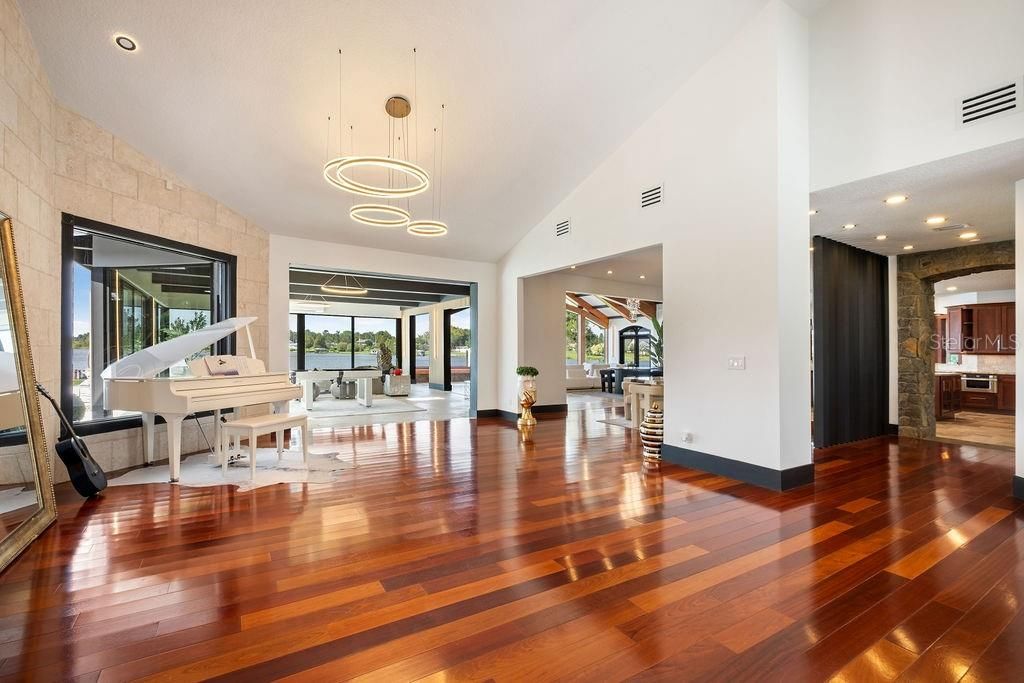 Fireplace, Interior, Pendant Lights, Piano, Recessed Lighting, Stone Walls, Wood Texture Flooring