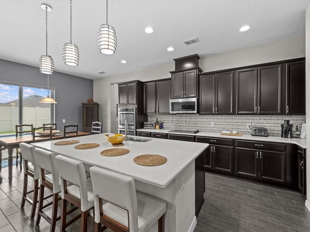 Dining room, Interior, Kitchen, Pendant Lights, Recessed Lighting, Stainless Steel Appliances, Wood Texture Flooring
