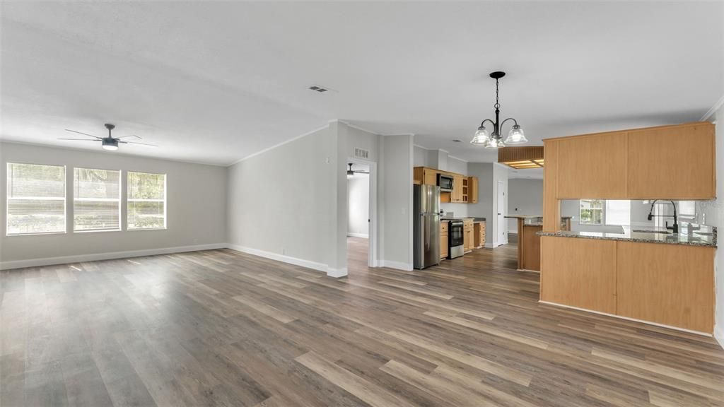 Chandelier, Empty room, Interior, Kitchen, Pendant Lights, Stainless Steel Appliances, Wood Texture Flooring
