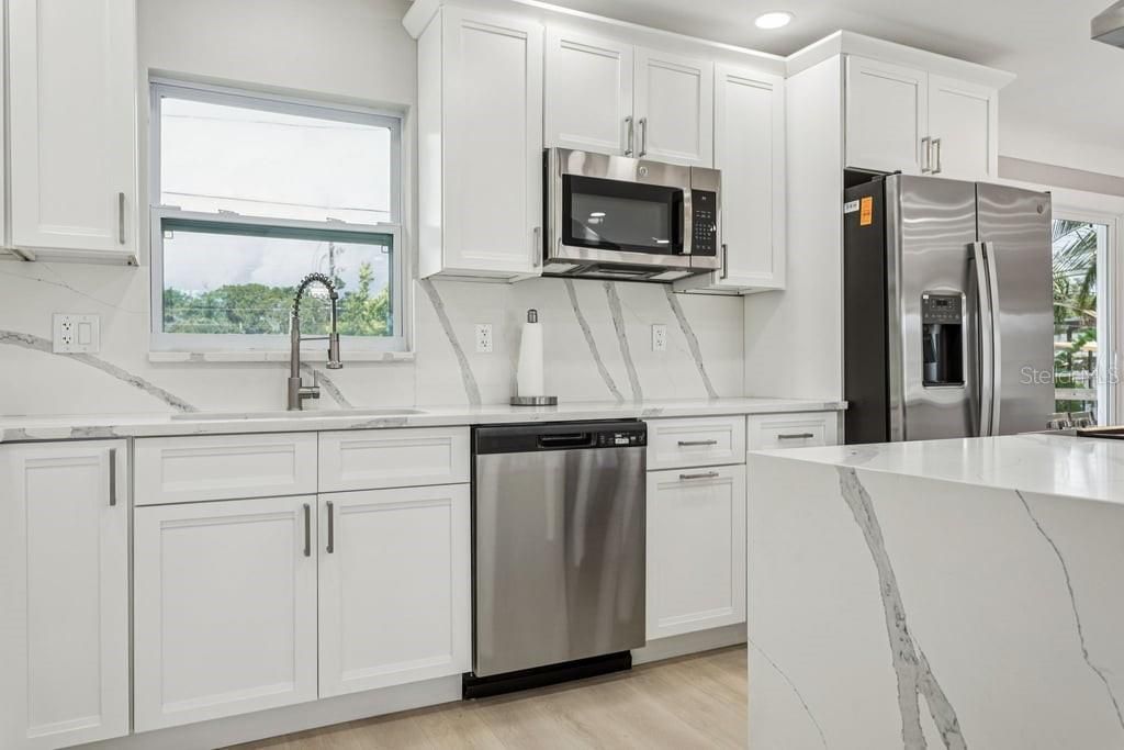 Interior, Kitchen, Marble Walls, Recessed Lighting, Stainless Steel Appliances, Wood Texture Flooring