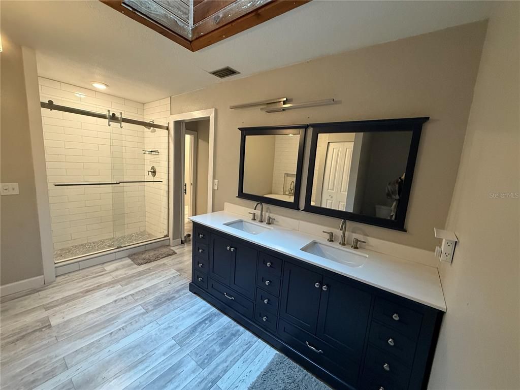 Bathroom, Dual Sink Vanities, Glass Shower, Interior, Recessed Lighting, Wood Texture Flooring