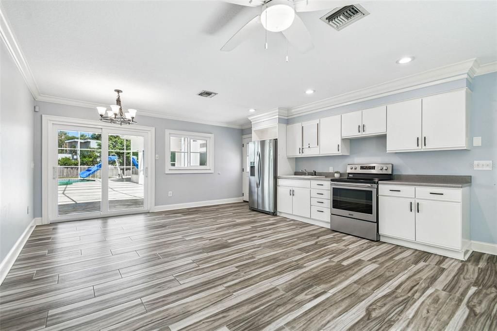 Chandelier, Empty room, Interior, Kitchen, Recessed Lighting, Stainless Steel Appliances, Wood Texture Flooring