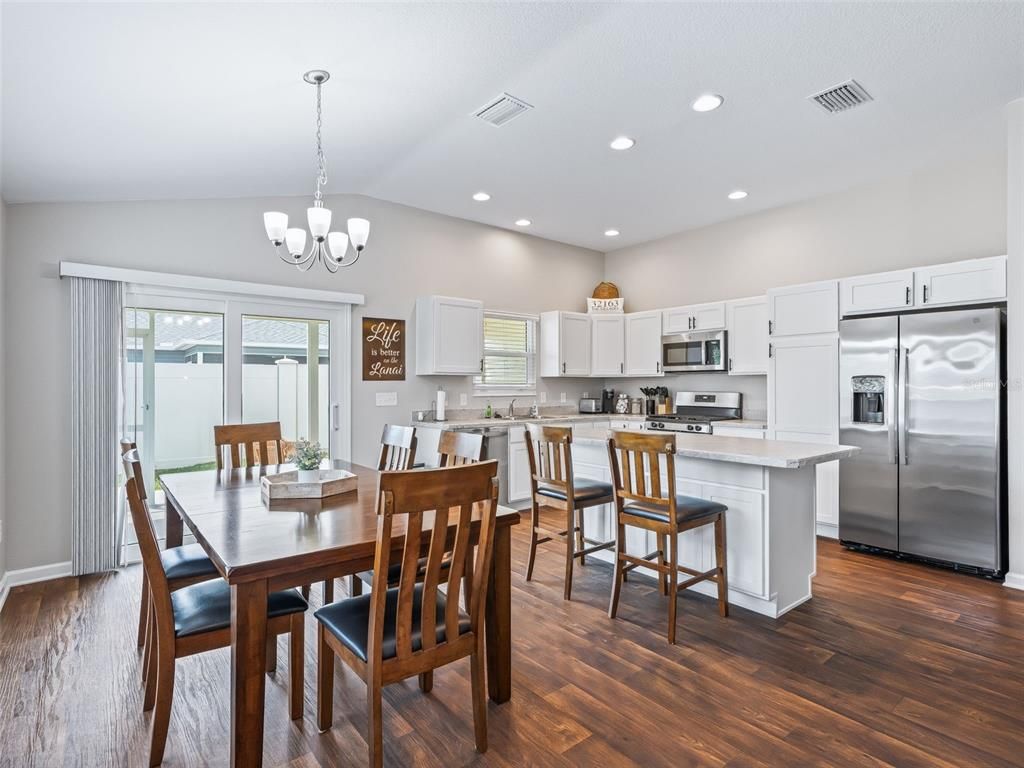 Chandelier, Dining room, Interior, Kitchen, Recessed Lighting, Stainless Steel Appliances, Wood Texture Flooring