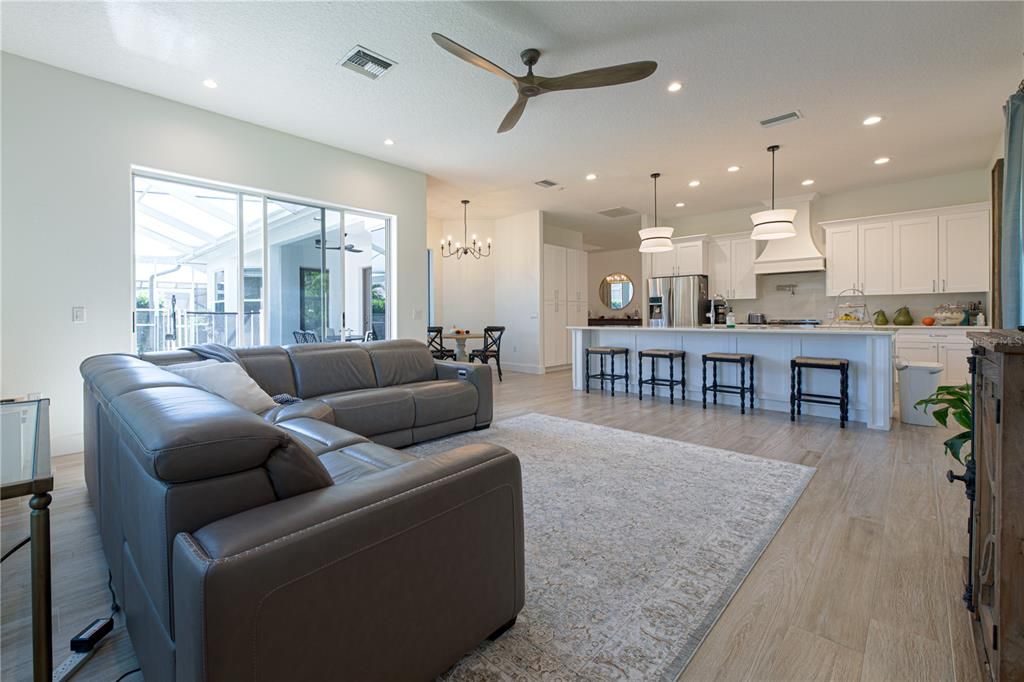 Chandelier, Dining room, Interior, Kitchen, Living room, Pendant Lights, Recessed Lighting, Stainless Steel Appliances, Wood Texture Flooring