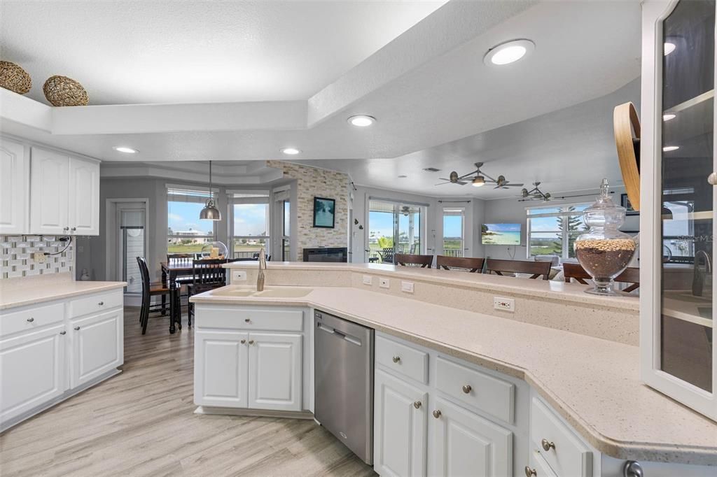 Dining room, Fireplace, Interior, Kitchen, Pendant Lights, Recessed Lighting, Stainless Steel Appliances, Stone Walls, Wood Texture Flooring