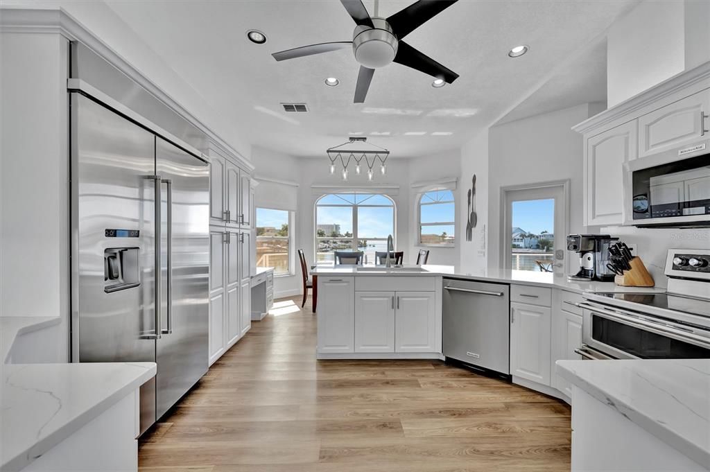 Dining room, Interior, Kitchen, Pendant Lights, Recessed Lighting, Stainless Steel Appliances, Water, Wood Texture Flooring