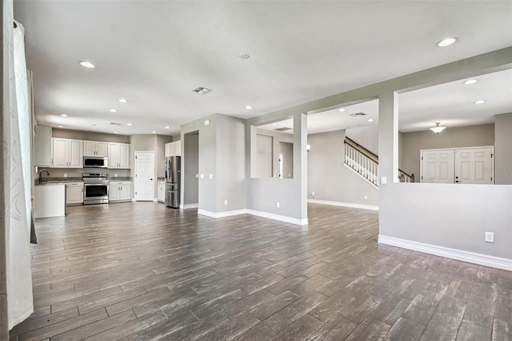 Empty room, Interior, Kitchen, Recessed Lighting, Stainless Steel Appliances, Wood Texture Flooring