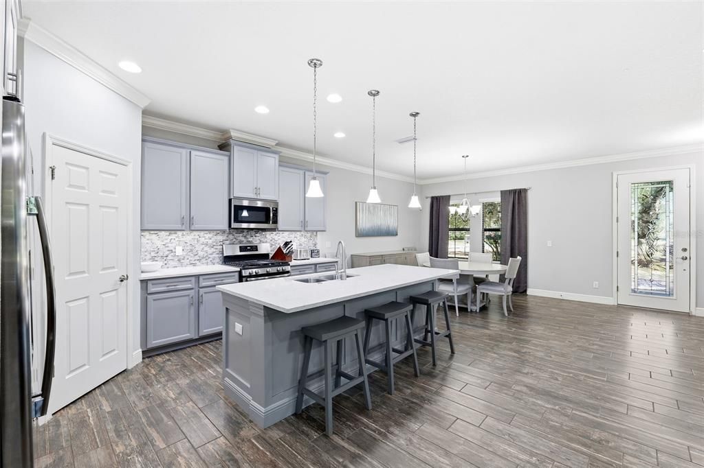 Dining room, Interior, Kitchen, Pendant Lights, Recessed Lighting, Stainless Steel Appliances, Wood Texture Flooring