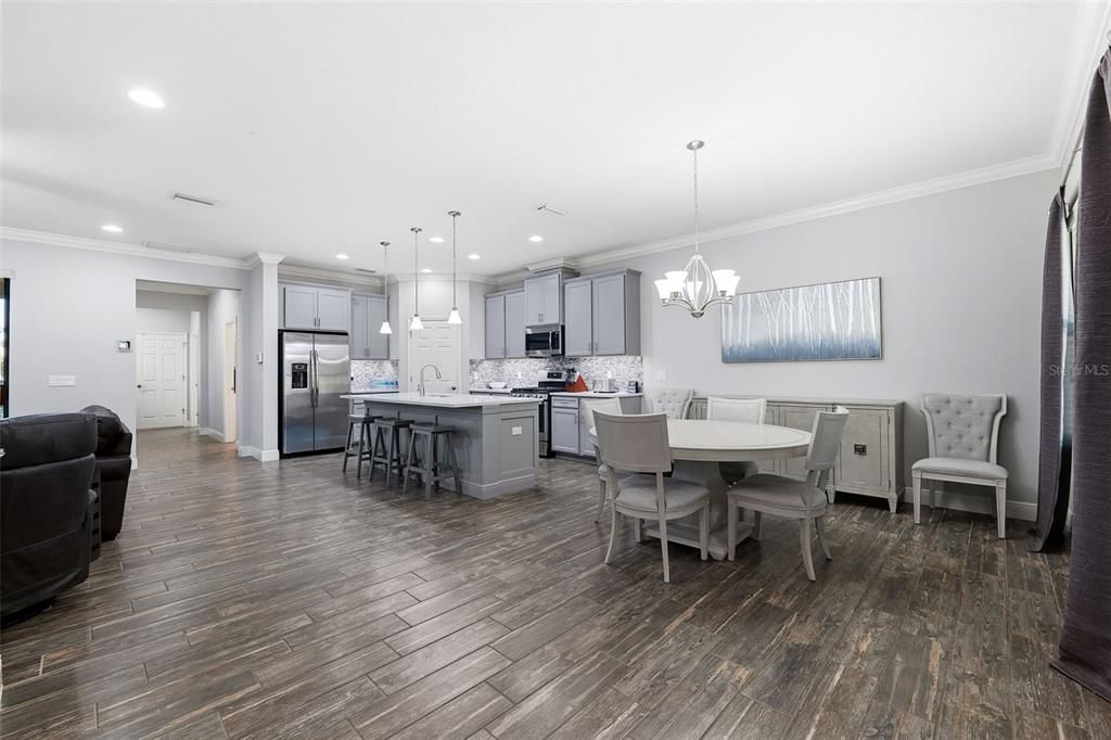 Chandelier, Dining room, Interior, Kitchen, Pendant Lights, Recessed Lighting, Stainless Steel Appliances, Wood Texture Flooring