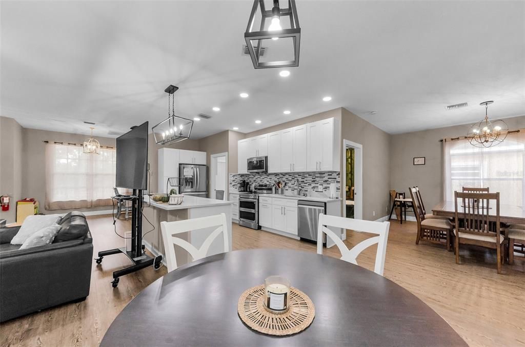 Chandelier, Dining room, Interior, Kitchen, Pendant Lights, Recessed Lighting, Stainless Steel Appliances, Wood Texture Flooring