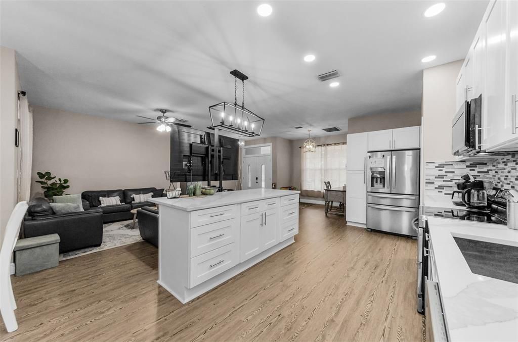 Chandelier, Interior, Kitchen, Living room, Pendant Lights, Recessed Lighting, Stainless Steel Appliances, Wood Texture Flooring