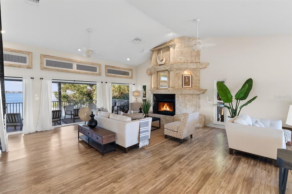 Chandelier, Fireplace, Interior, Living room, Recessed Lighting, Water, Wood Texture Flooring