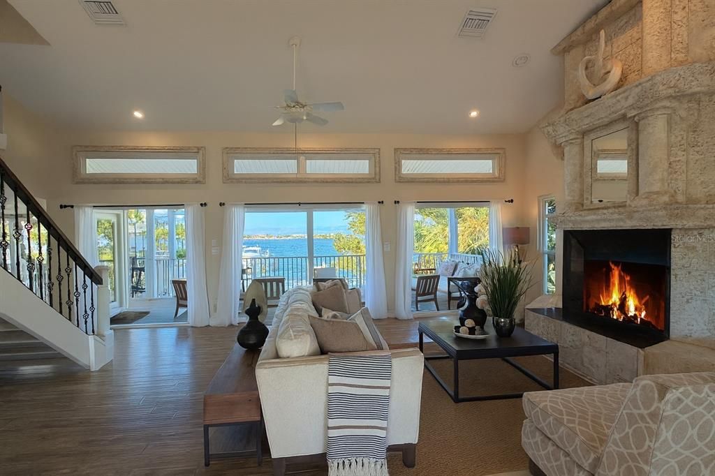 Fireplace, Interior, Living room, Recessed Lighting, Stone Walls, Water, Wood Texture Flooring