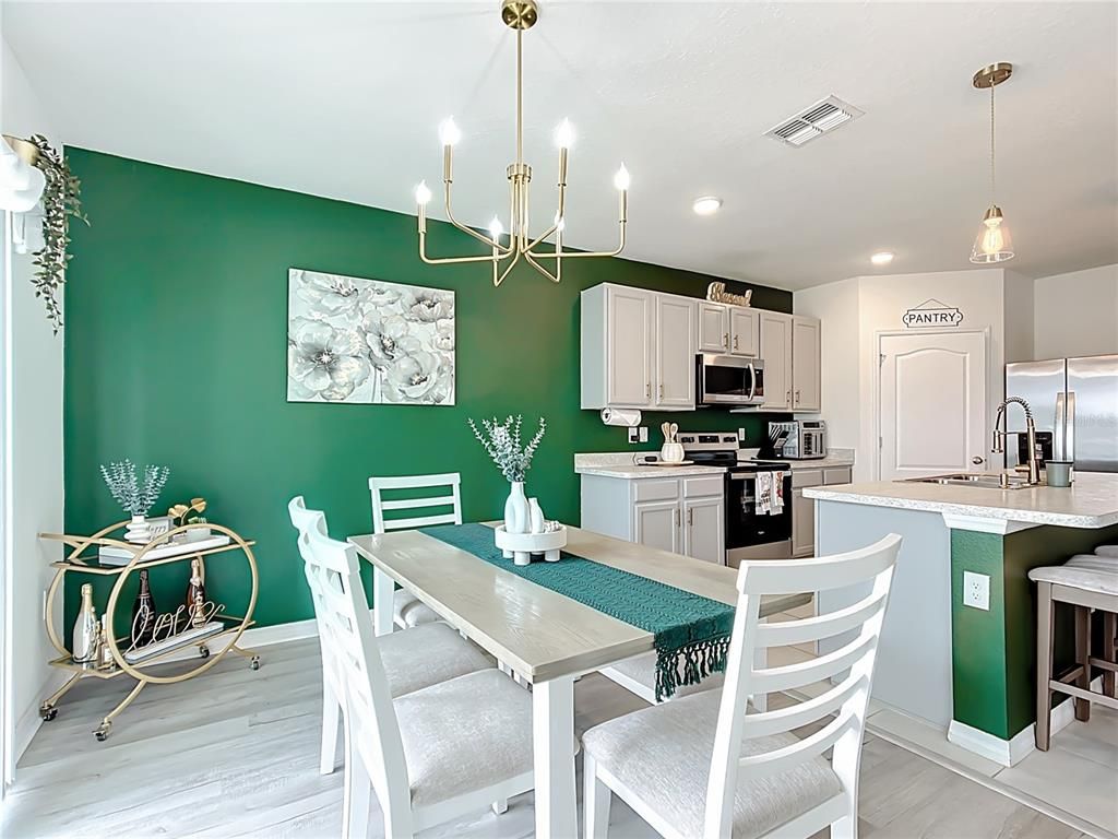 Chandelier, Dining room, Interior, Kitchen, Pendant Lights, Recessed Lighting, Stainless Steel Appliances, Wood Texture Flooring