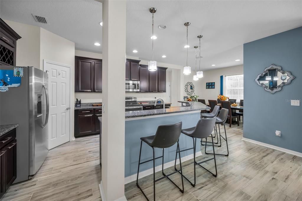 Dining room, Interior, Kitchen, Pendant Lights, Recessed Lighting, Stainless Steel Appliances, Wood Texture Flooring