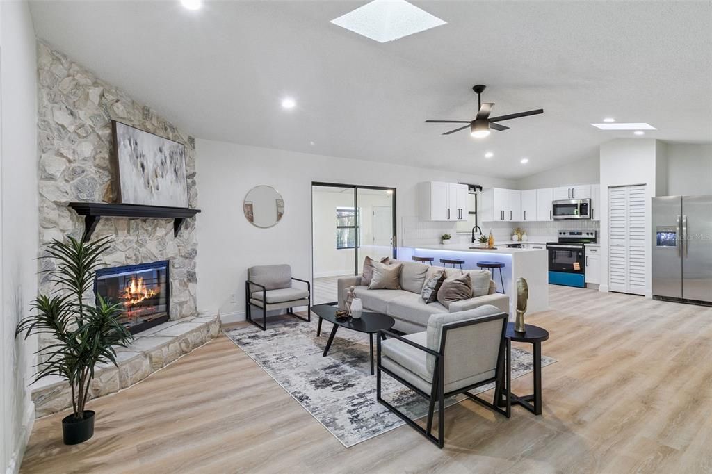 Fireplace, Interior, Kitchen, Living room, Recessed Lighting, Stainless Steel Appliances, Stone Walls, Wood Texture Flooring