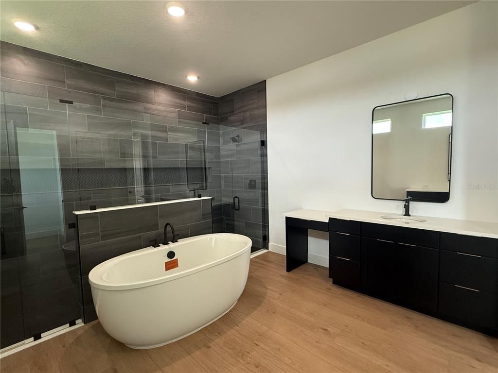 Bathroom, Dual Sink Vanities, Free Standing Baths, Glass Shower, Interior, Recessed Lighting, Wood Texture Flooring