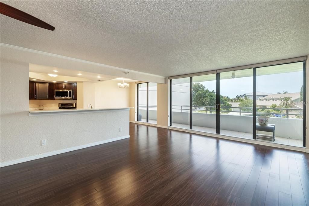 Chandelier, Empty room, Interior, Kitchen, Recessed Lighting, Stainless Steel Appliances, Wood Texture Flooring