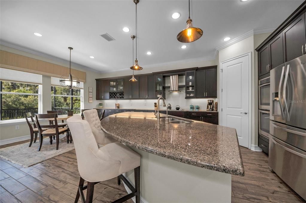 Dining room, Interior, Kitchen, Pendant Lights, Recessed Lighting, Stainless Steel Appliances, Wood Texture Flooring