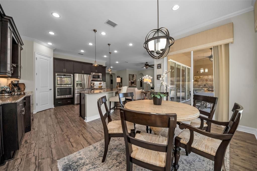 Dining room, Interior, Kitchen, Pendant Lights, Recessed Lighting, Stainless Steel Appliances, Wood Texture Flooring