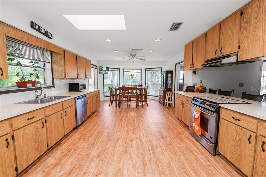 Dining room, Interior, Kitchen, Recessed Lighting, Stainless Steel Appliances, Wood Texture Flooring