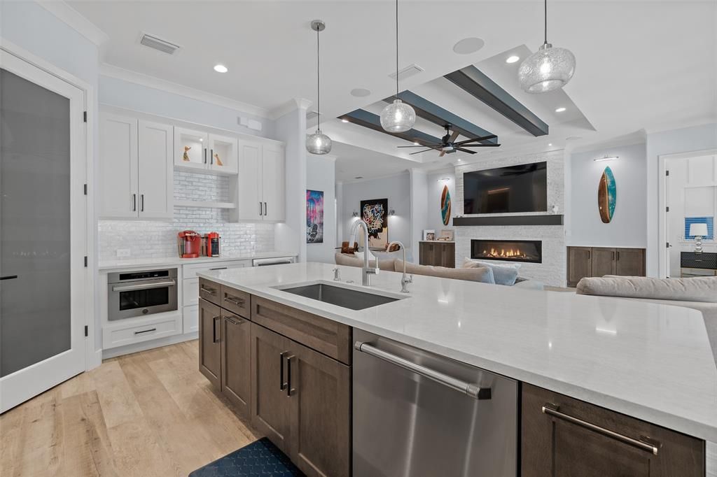 Fireplace, Interior, Kitchen, Pendant Lights, Recessed Lighting, Stainless Steel Appliances, Stone Walls, Wood Texture Flooring