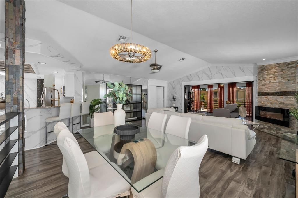 Chandelier, Dining room, Fireplace, Interior, Living room, Pendant Lights, Recessed Lighting, Stone Walls, Wood Texture Flooring