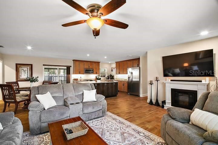 Dining room, Fireplace, Interior, Kitchen, Living room, Recessed Lighting, Stainless Steel Appliances, Wood Texture Flooring