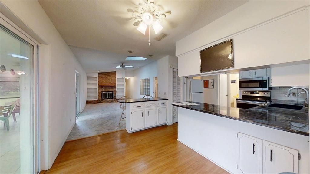 Fireplace, Interior, Kitchen, Stainless Steel Appliances, Wood Texture Flooring