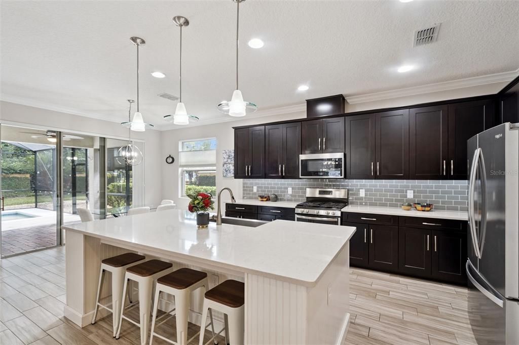 Dining room, Interior, Kitchen, Pendant Lights, Recessed Lighting, Stainless Steel Appliances, Wood Texture Flooring