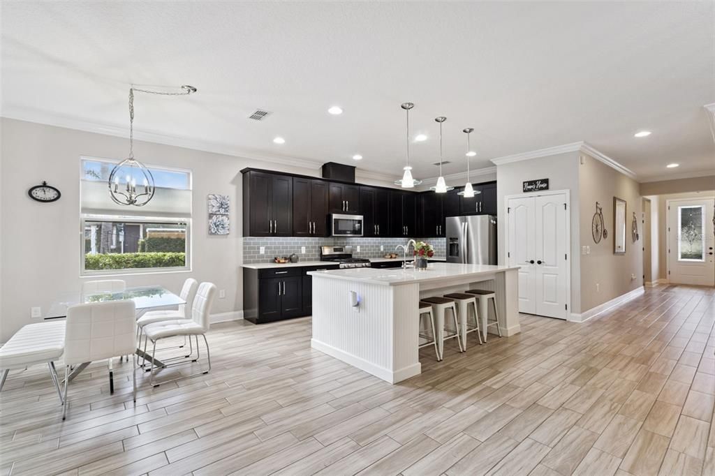 Dining room, Interior, Kitchen, Pendant Lights, Recessed Lighting, Stainless Steel Appliances, Wood Texture Flooring