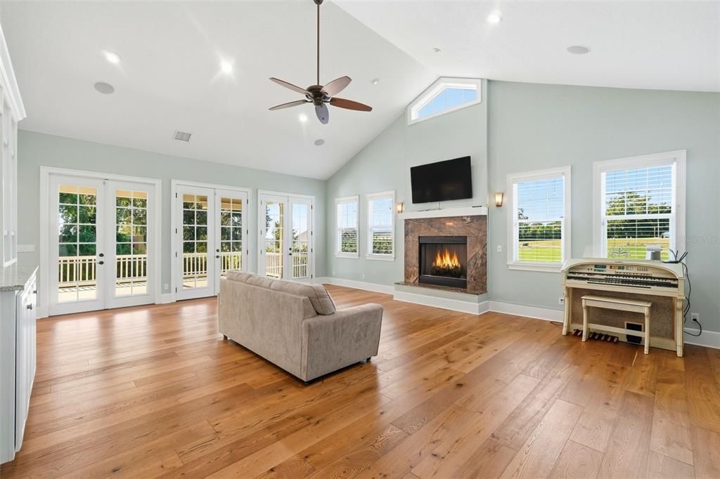 Fireplace, Interior, Living room, Piano, Recessed Lighting, Wood Texture Flooring