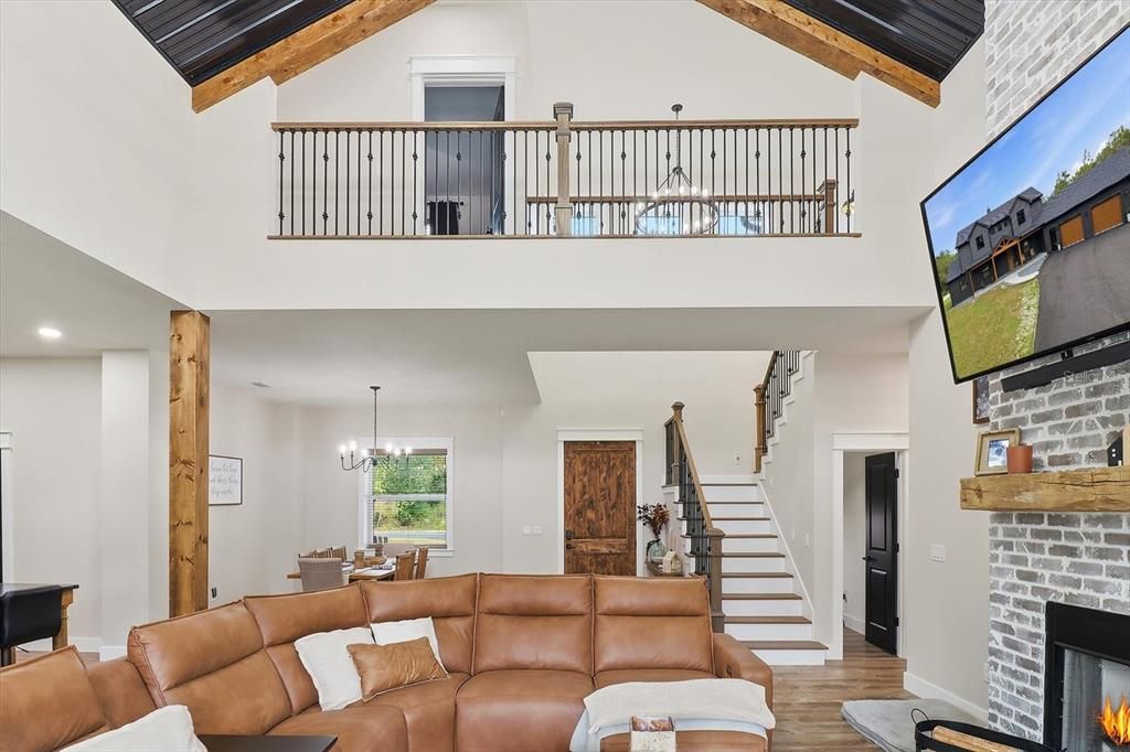 Chandelier, Dining room, Fireplace, Interior, Living room, Recessed Lighting, Stone Walls, Wooden Beams, Wood Texture Flooring