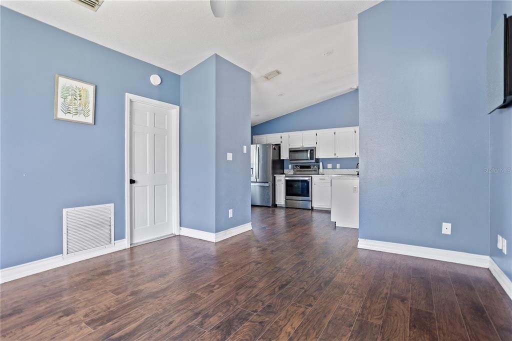 Empty room, Interior, Kitchen, Recessed Lighting, Stainless Steel Appliances, Wood Texture Flooring