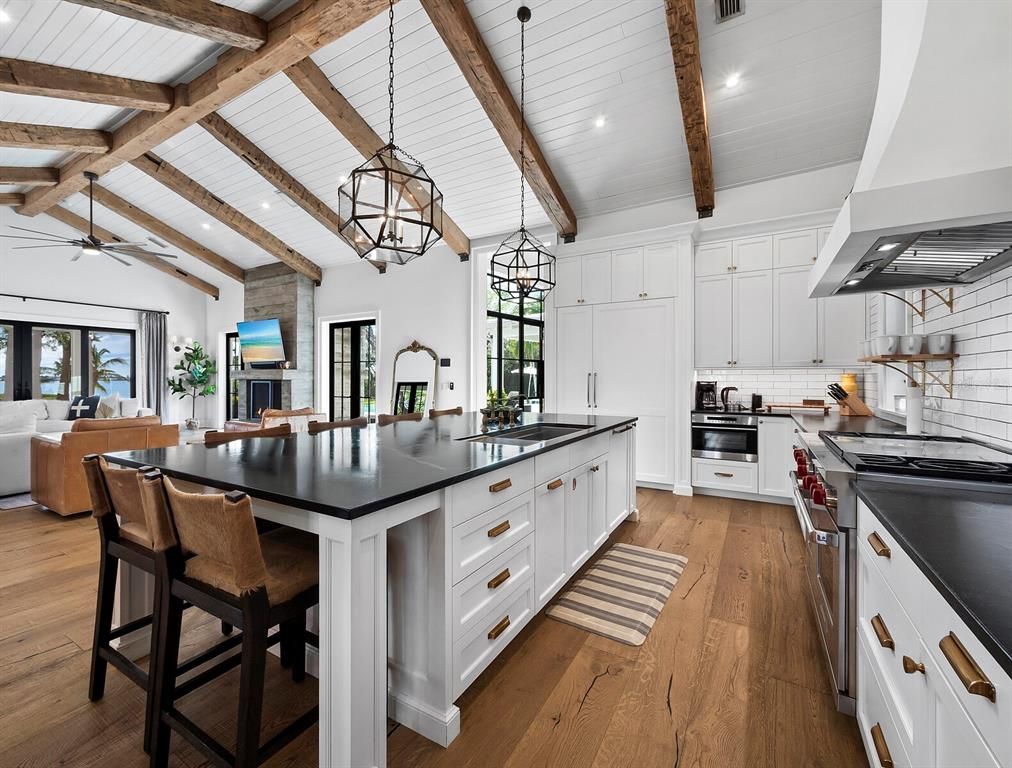 Chandelier, Interior, Kitchen, Living room, Pendant Lights, Recessed Lighting, Stainless Steel Appliances, Wooden Beams, Wood Texture Flooring