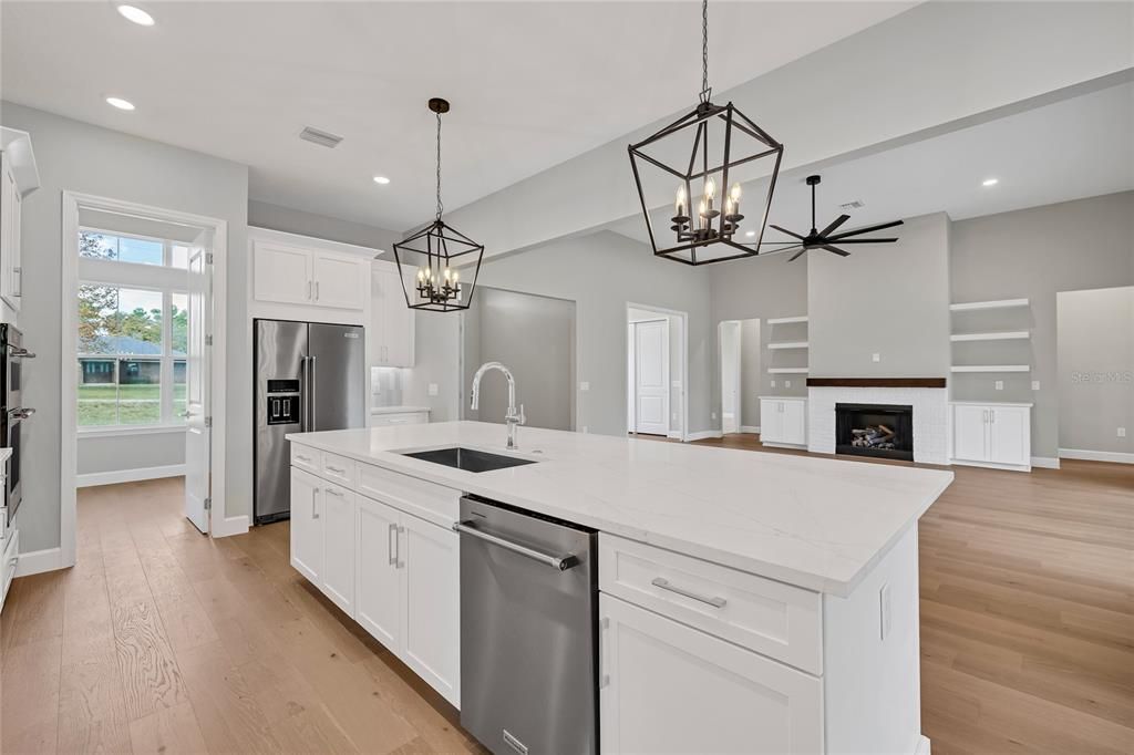 Fireplace, Interior, Kitchen, Pendant Lights, Recessed Lighting, Stainless Steel Appliances, Wood Texture Flooring